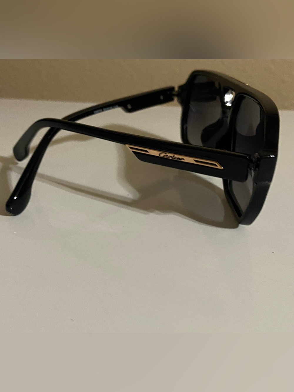 Cartier Black Sunglasses with Gold Temple Detail